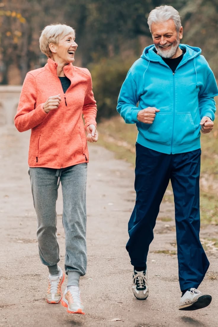 Older couple smiling on a brisk walk outdoors